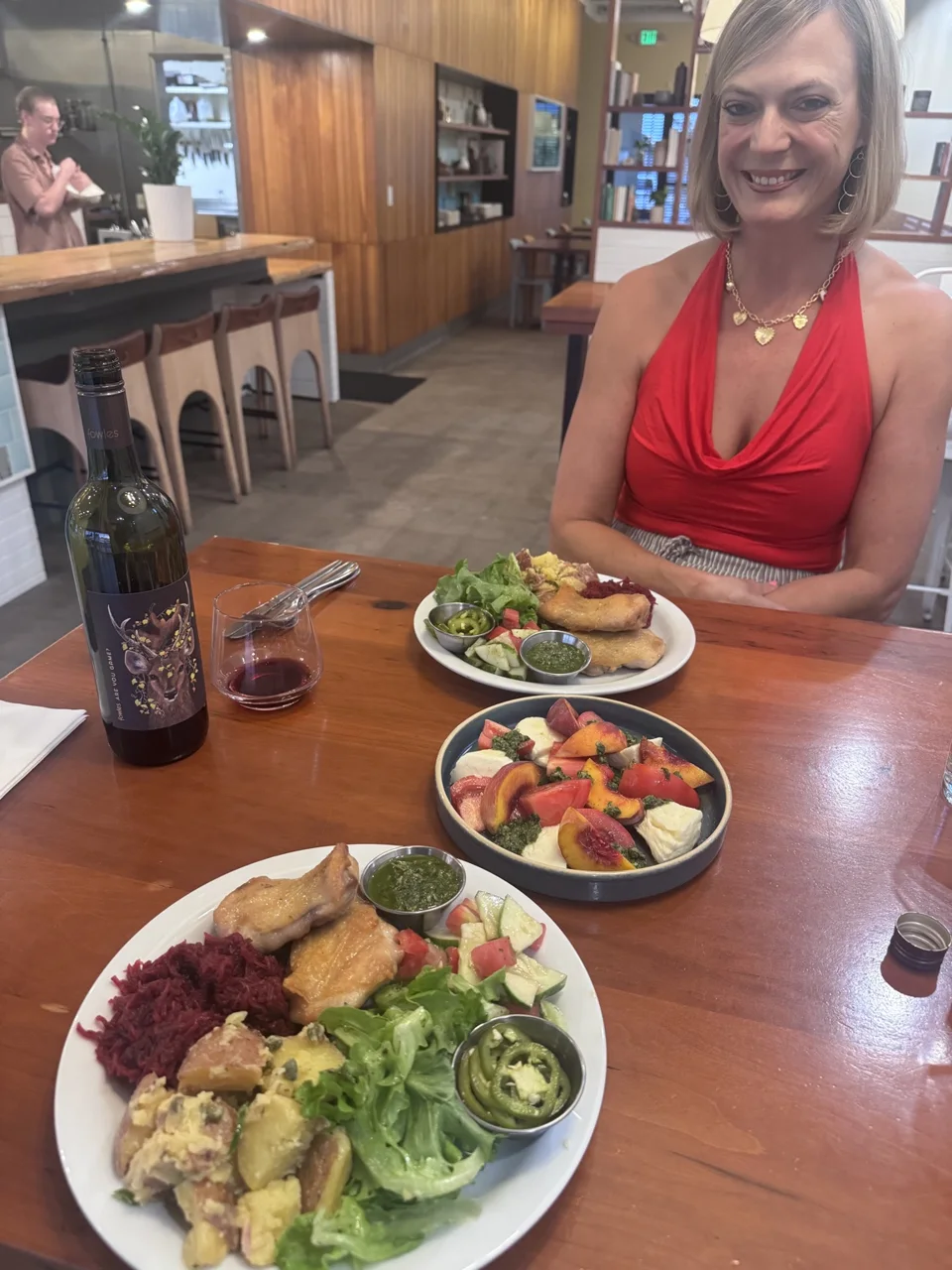 Jen at Picnik with roasted chicken, salads and a bottle of wine