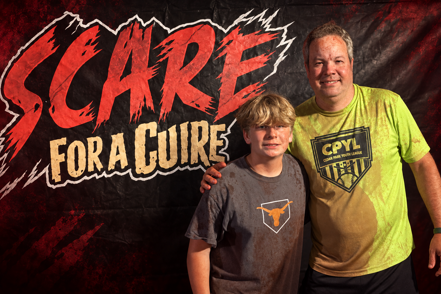 Mark and his oldest son with the SCARE for a CURE logo after completing the adventure