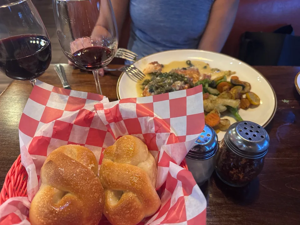 Dinner at Tutta Bella with warm bread, salmon, vegetables and wine