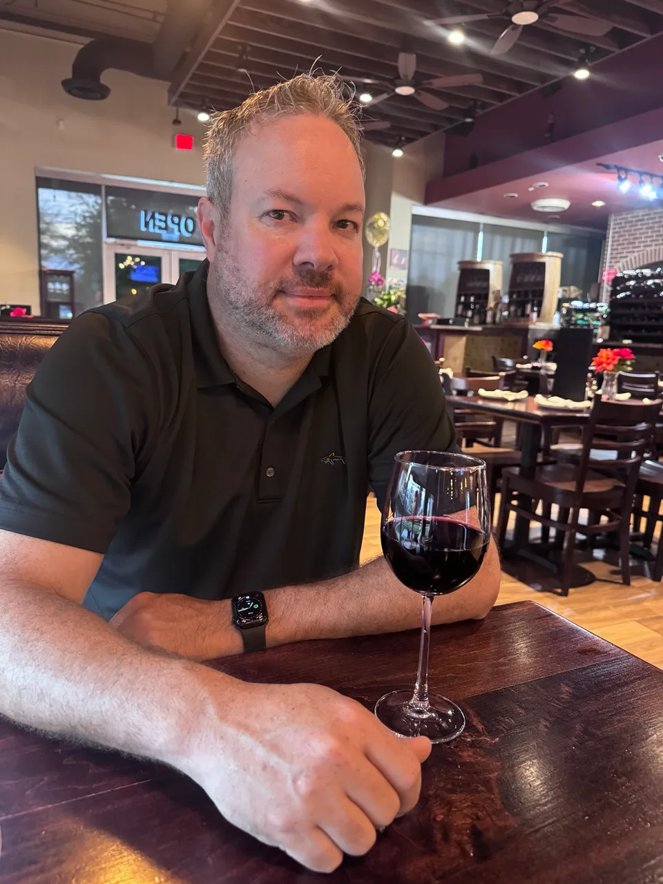 Mark enjoying a glass of wine at Tutta Bella